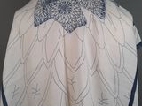 an image of a white and blue shawl on a mannequin