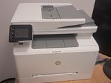 a printer sitting on top of a desk next to a computer