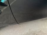 a black car parked on the side of the street