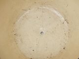 a white bowl with a hole in the middle of it