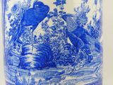 a blue and white vase with a picture of a bird on it