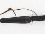 an old knife with a leather sheath hanging from it ' s side