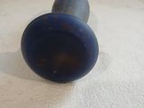 two blue knobs sitting on a white surface