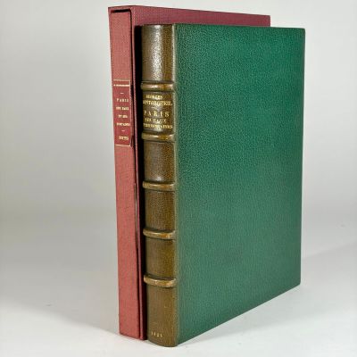 a green book with a red cover and a gold binding