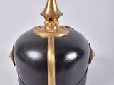 a black and gold container with a gold top