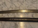 two old swords sitting on top of a marble counter top