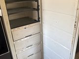 an old refrigerator that has been left open in the kitchen