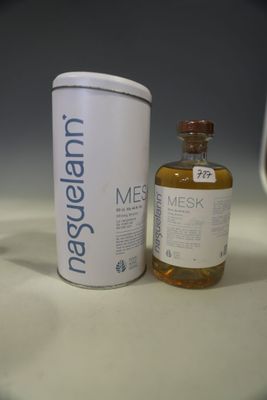 a bottle of liquid next to a canister of liquid