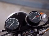 two gauges on the handlebars of a motorcycle