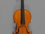 an old violin with a bow hanging on a wall