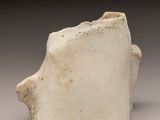 a close up of a white vase on a table