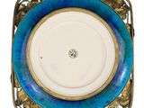 a blue and gold plate with a gold rim
