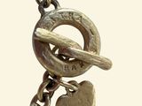 a close up of a key and a heart on a chain