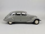 an old model of a silver car on a white background