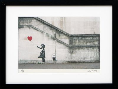 framed picture of a girl with a red balloon in a black frame