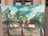 un tableau posé sur un chevalet dans une pièce