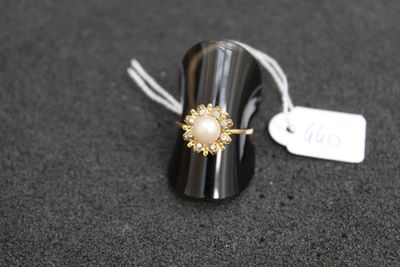 a close up of a ring on a black surface with a price tag