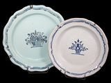 two plates with blue designs on them on a black background