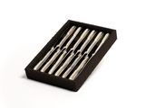 six forks in a black box on a white surface
