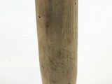a small wooden pole with a black base on a white surface