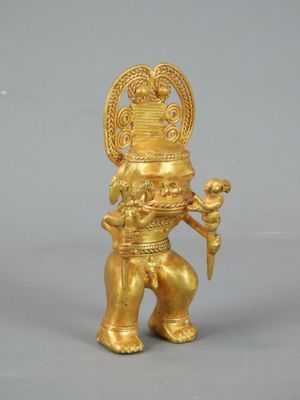 an image of a gold statue of a person holding a bird