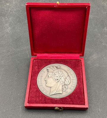 a silver coin in a red box on a table
