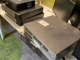 many computers and monitors on the desk in this office