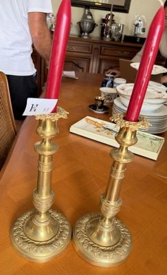two candles that are sitting on a wooden table