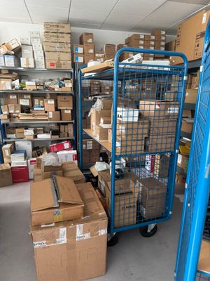 a blue cart with boxes on it in a warehouse
