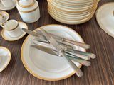 a lot of plates and silverware on the table