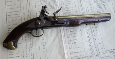 an old gun that is on top of a sheet of paper