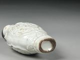 a white vase that has a handle on it