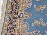 a blue area rug with a floral design on it