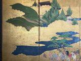 a painting on the wall of a building with people walking by