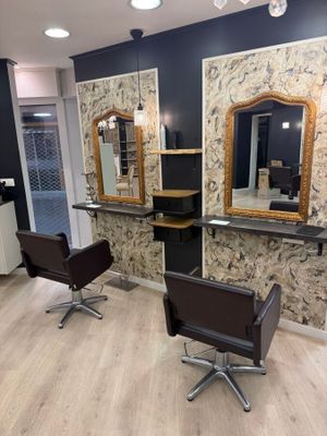 two chairs in a room with mirrors on the wall