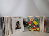a lot of records sitting on a table next to each other