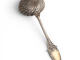 a close up of a spoon on a white surface