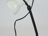 an image of a black and white desk lamp on a white surface