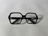 black glasses on a white surface with a white background