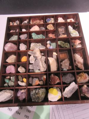 a wooden box filled with different types of rocks and minerals