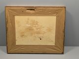 an old picture frame sitting on top of a white table