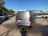 a silver van that is parked in a parking lot