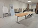 a room with a table and a whiteboard on the wall
