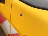 a close up of a yellow car with a sticker on it