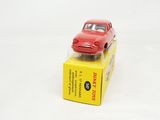 a red toy car sitting on top of a yellow box