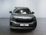the front view of a silver car parked in a showroom
