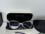 sunglasses and a pair of glasses sitting on a table next to a pair of glasses