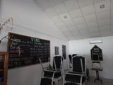 many chairs in a room with a chalk board on the wall