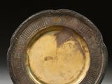 a gold plate with a picture of a man on it