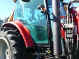 a red tractor that is parked on the side of the road